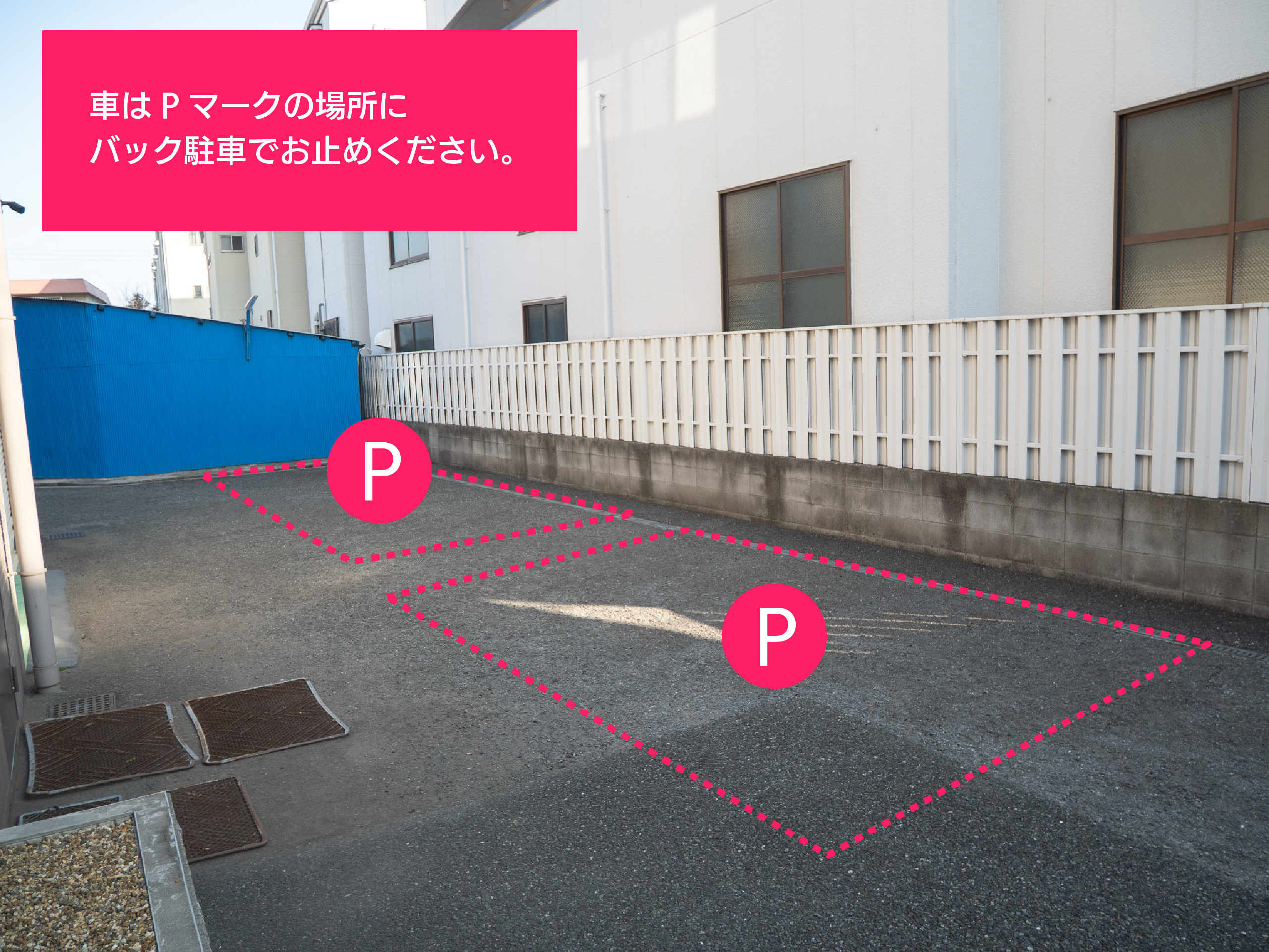 お客様駐車場の詳細写真。駐車スペースをピンクの点線とPマークで囲み、「車はPマークの場所にバック駐車でお止めください。」という指示が記載されています。